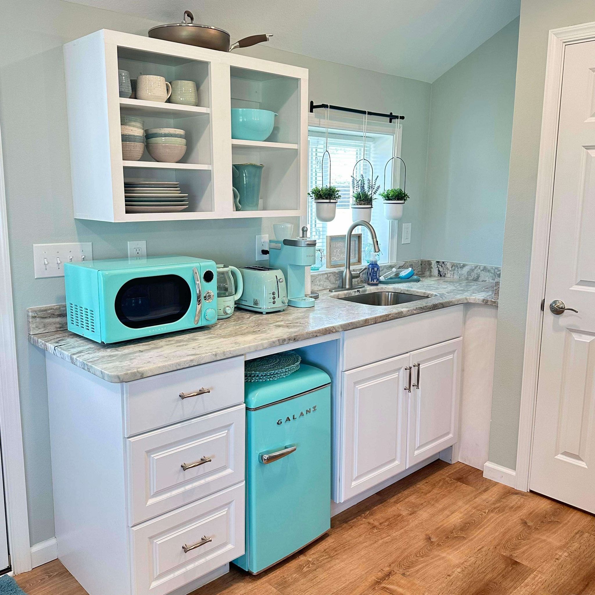 Turquoise retro kitchen with white cabinets
