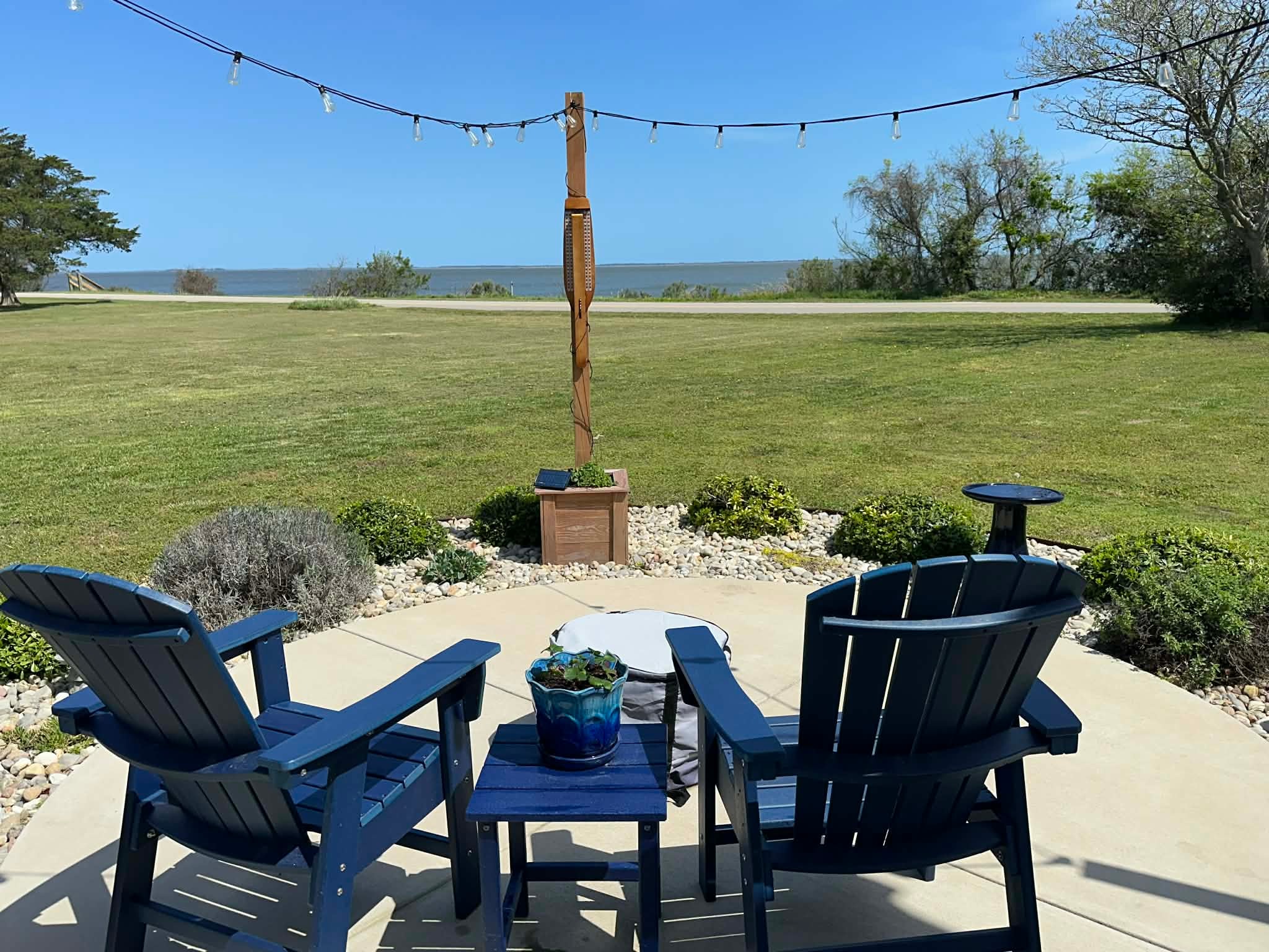 Backyard patio with picnic table and landscaping